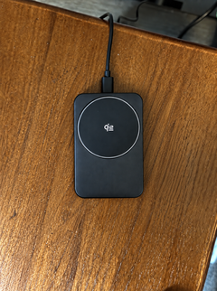Store-supplied sample image of a folded black charger on wood